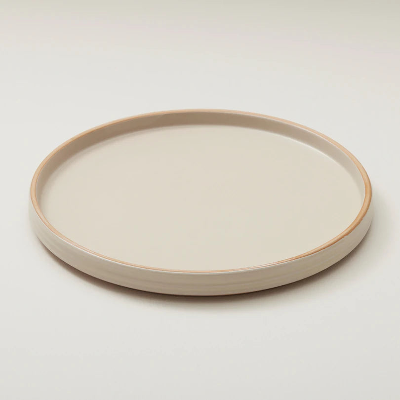 stoneware dinner plates with subtle ridged pattern and a matte mottled glaze.