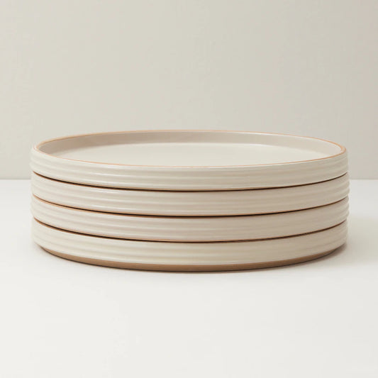 stoneware dinner plates with subtle ridged pattern and a matte mottled glaze.